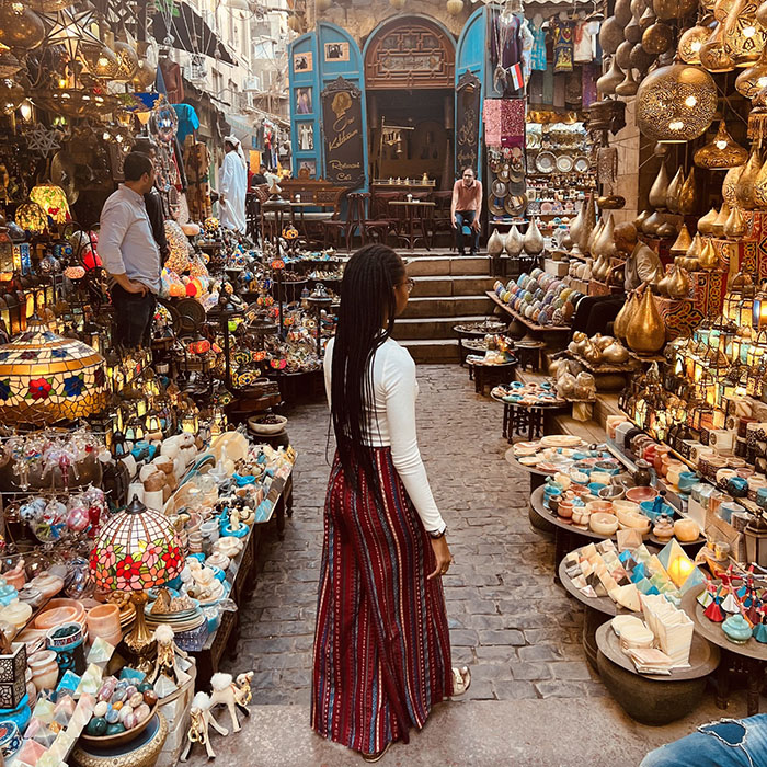 Bard Abroad ColumnBack of young woman standing in a street market in Cairo, Egypt.